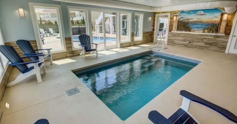 Elegant indoor pool with aesthetic interior design by RBC Homes