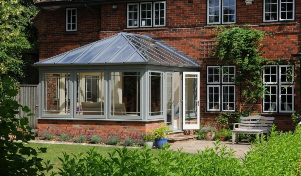 Wooden conservatory on red brick house with eco-friendly design