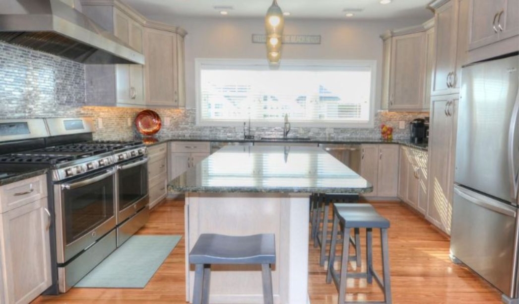 The Attitude Adjustment custom kitchen with granite countertop, high-end stainless steel appliances, and modern design