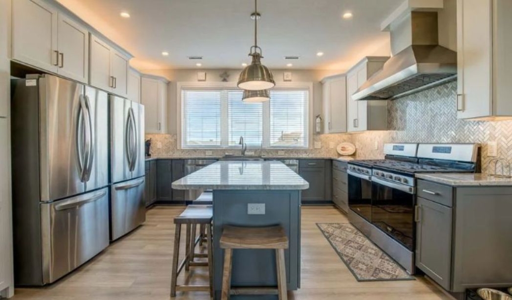 The X-TA-SEA kitchen with modern space features, white cabinetry, stainless steel appliances, and contemporary looks