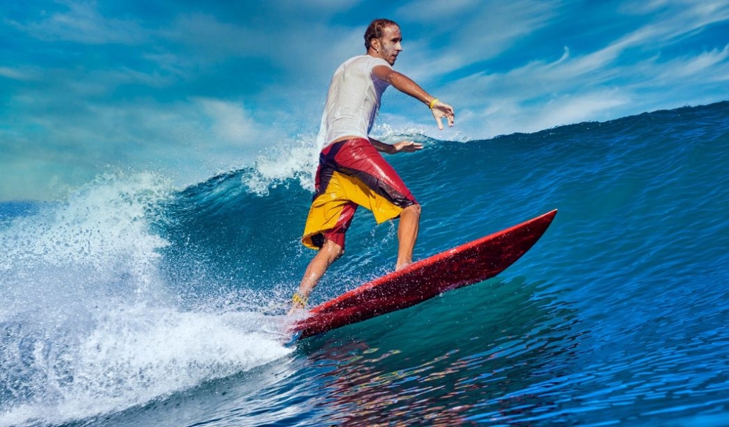 A man skillfully rides a wave on his surfboard during the East Coast Surfing Championships.