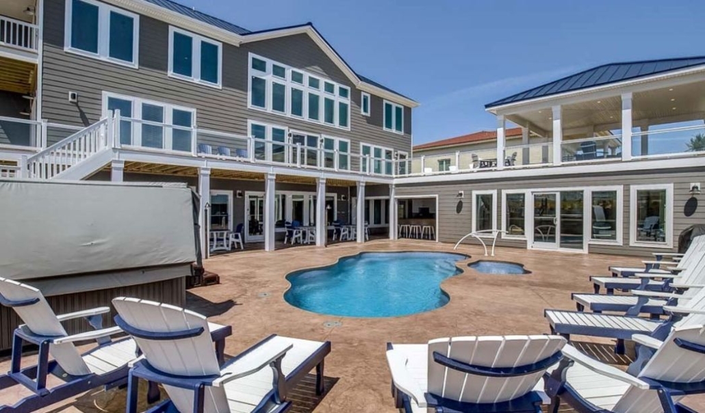 A tranquil poolside deck with inviting chairs, perfect for leisure and enhancing your dream home experience with RBC Homes.