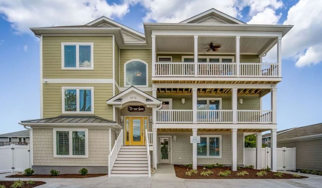 Front view of a two-story home featuring a balcony, illustrating seasonal home maintenance checklist.