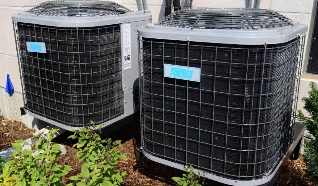 Two air conditioning units located outside a building, emphasizing the importance of HVAC maintenance for year-round safety.