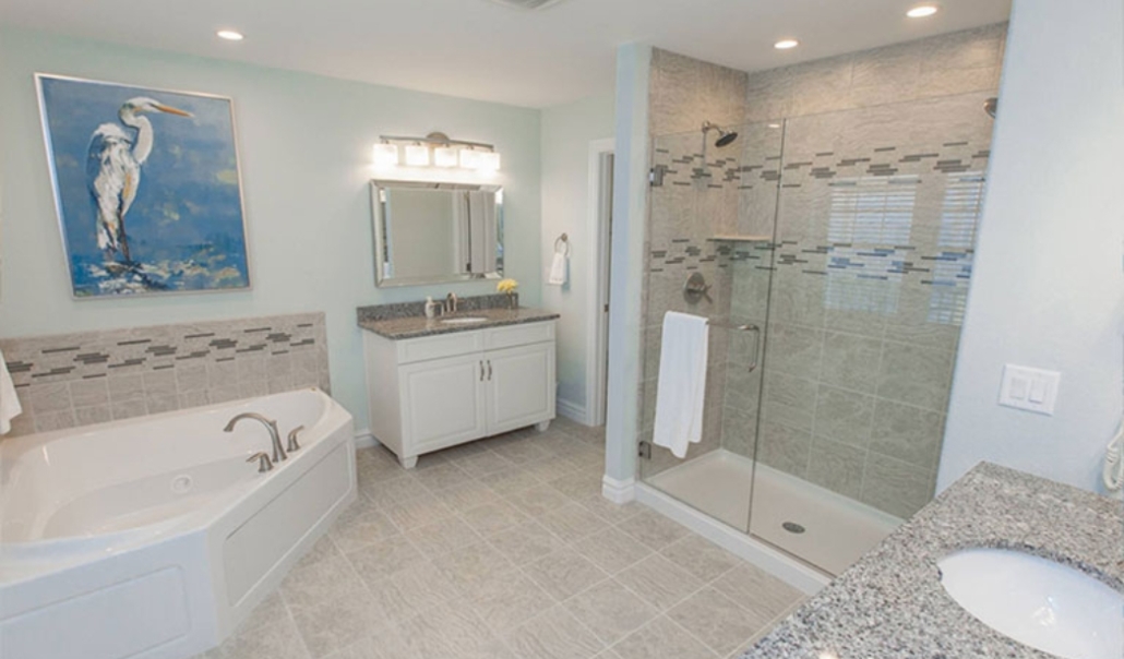 A clean bathroom showcasing a shower, sink, and tub, highlighting the need for regular home cleaning.