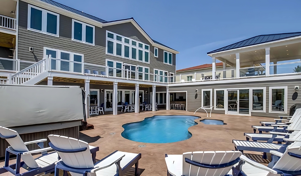 Elegant poolside deck with chairs, showcasing the craftsmanship of Courthouse Estates Virginia Beach Home Builders.