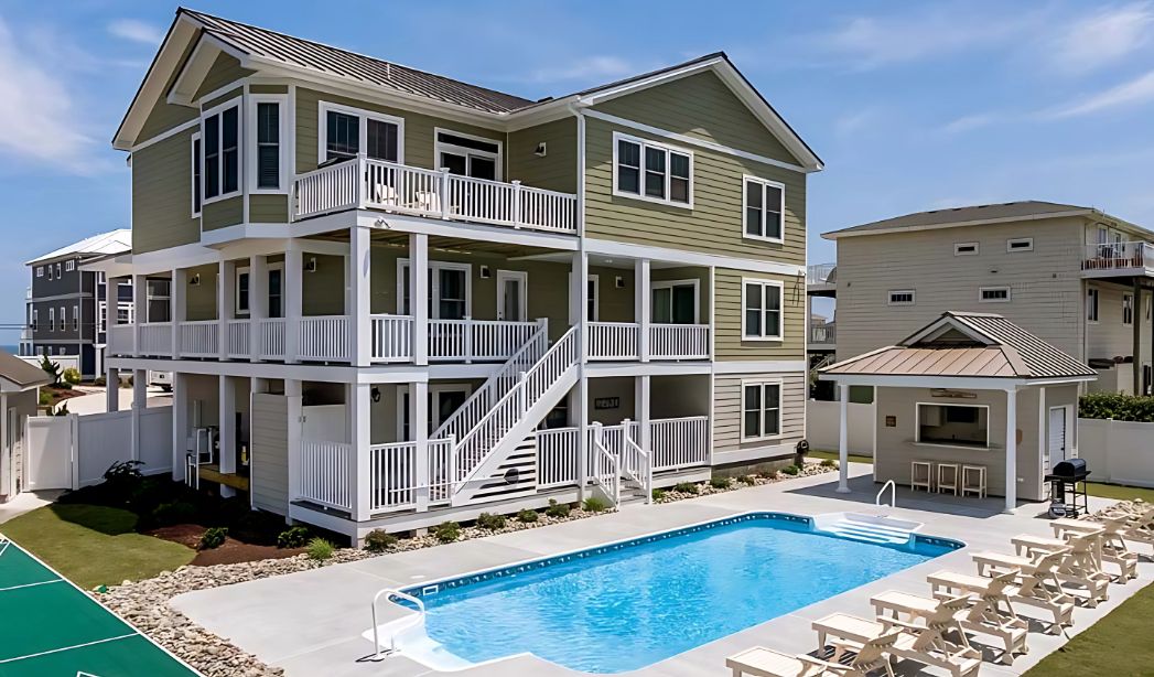 A beautiful house in Little Neck, Virginia Beach, featuring a pool and stylish decking in front.