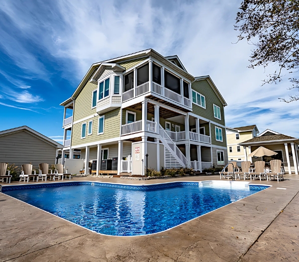 Charming house with a pool and deck in front, located in Little Neck, Virginia Beach, designed by local builders.