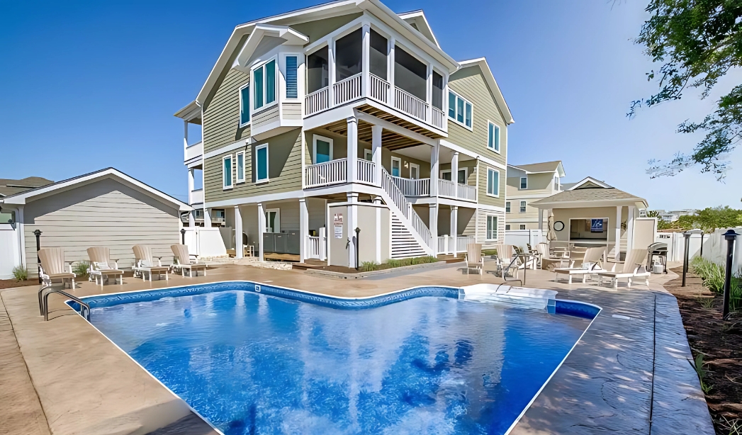 A beautiful house in Virginia Beach featuring a pool and elegant decking, showcasing Alanton's exceptional home building.