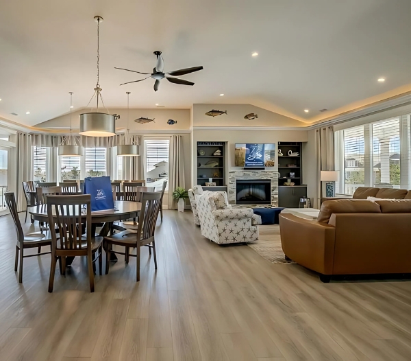 Spacious living and dining rooms with open access to the outdoor space in a Baycliff Virginia Beach residence.