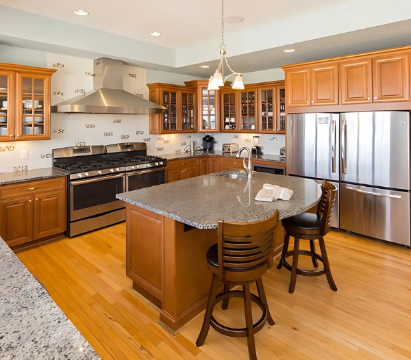 Contemporary kitchen with a central island and stainless steel appliances, exemplifying the superior craftsmanship of Baycliff, Virginia Beach.