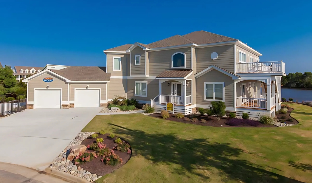 A spacious home featuring a driveway and garage, showcasing quality craftsmanship by Garage Builder Virginia Beach.