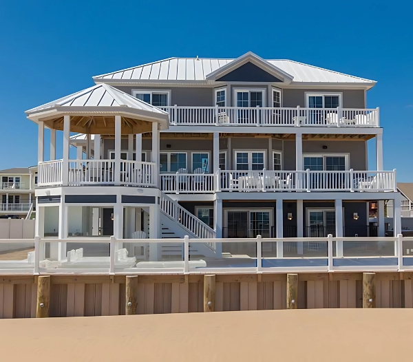 A beach house featuring a spacious deck and balcony, ideal for enjoying coastal views in Virginia Beach.