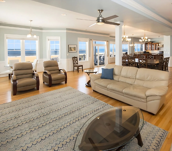 A spacious living room featuring a large couch and chairs, showcasing premium materials for home improvement in Virginia Beach.