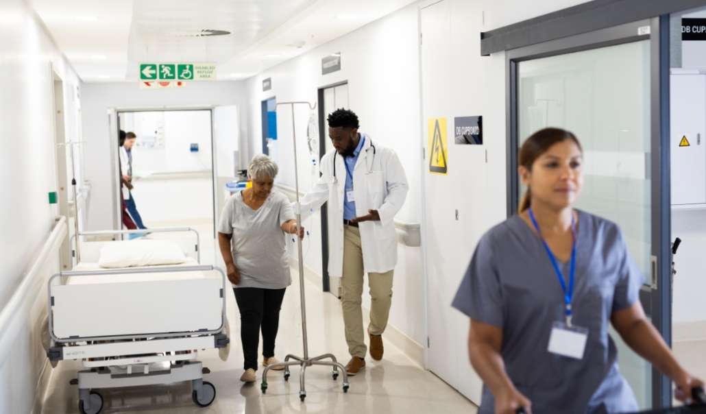 A patient and doctors walking in a hallway, illustrating the collaborative nature of healthcare in Virginia Beach.