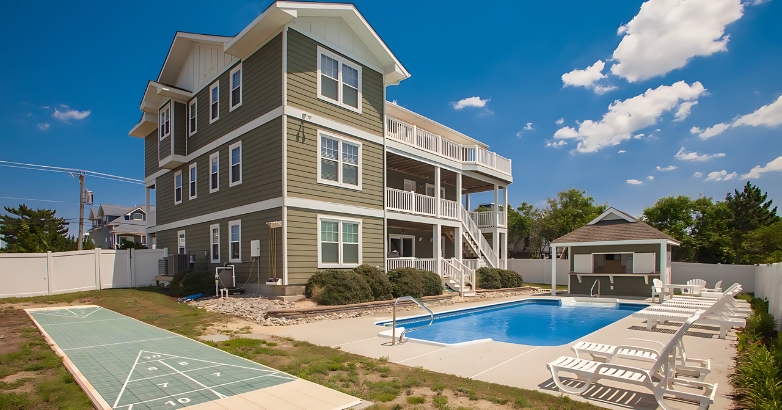 A picturesque blue house with a pool and deck, embodying the spirit of moving to Virginia Beach with Irish blessings.