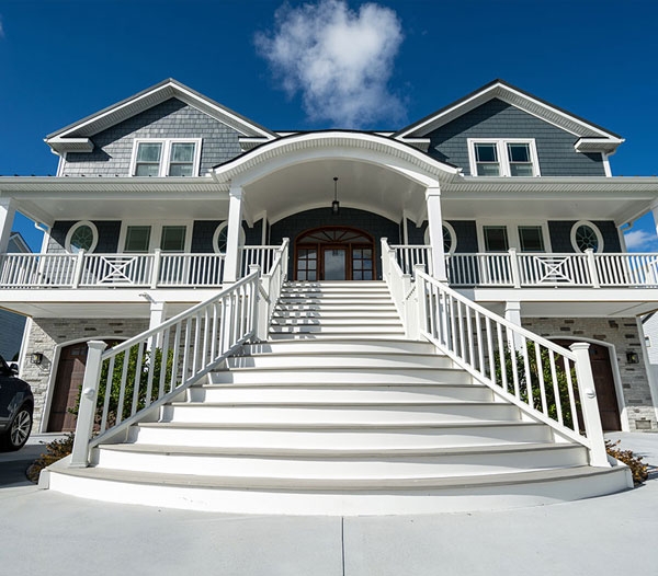 A spacious residence featuring stairs that ascend to the front door, reflecting the high standards of Castleton Home Builders.