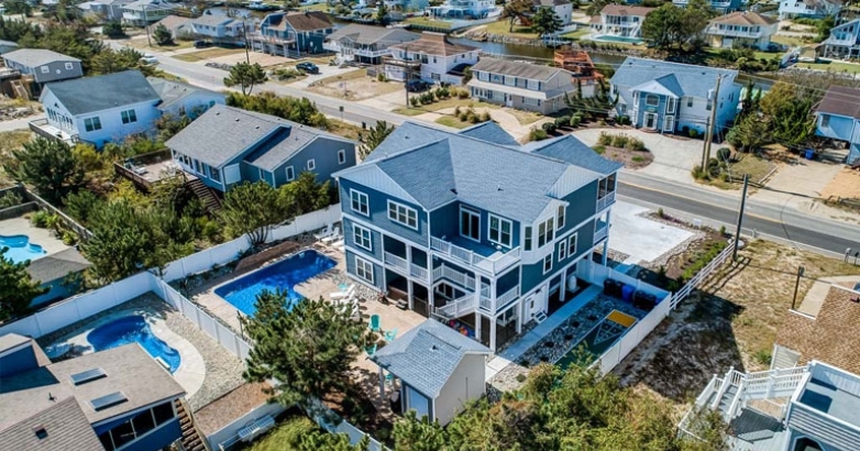 Aerial view of a beach house featuring a pool, showcasing a prime real estate investment opportunity in Virginia Beach.