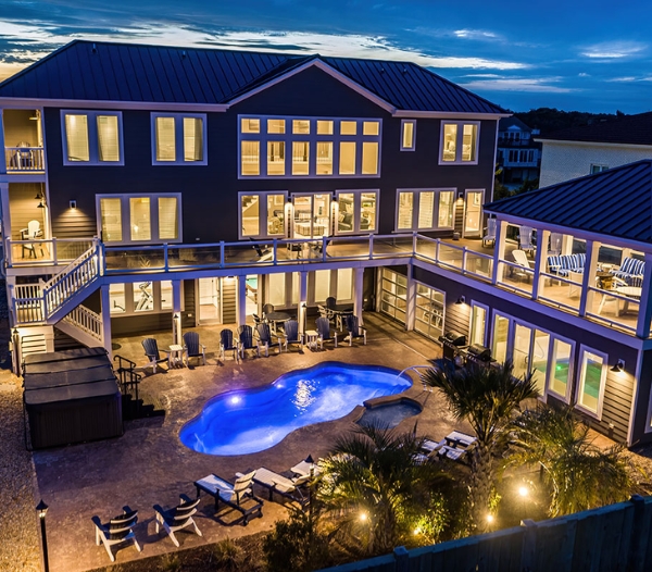 A large residence with a pool and deck, representing the long-term investment value of Bay Island Virginia Beach Homebuilders.