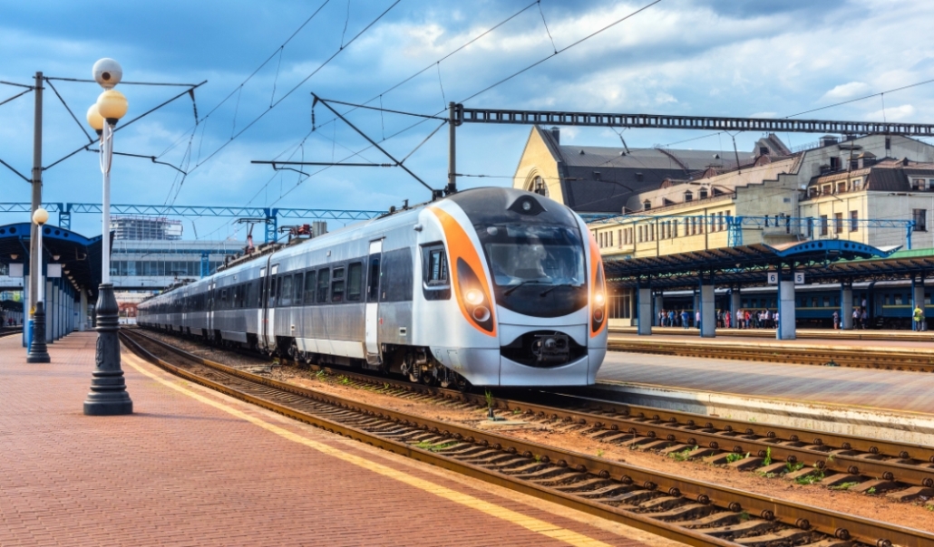 A train pulls into a station on a bright, sunny day, representing public transport in Virginia Beach.