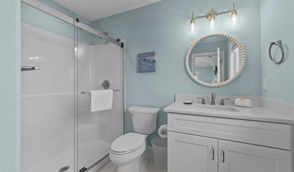 A modern bathroom featuring a shower stall and toilet, showcasing home improvement upgrades in Virginia Beach.