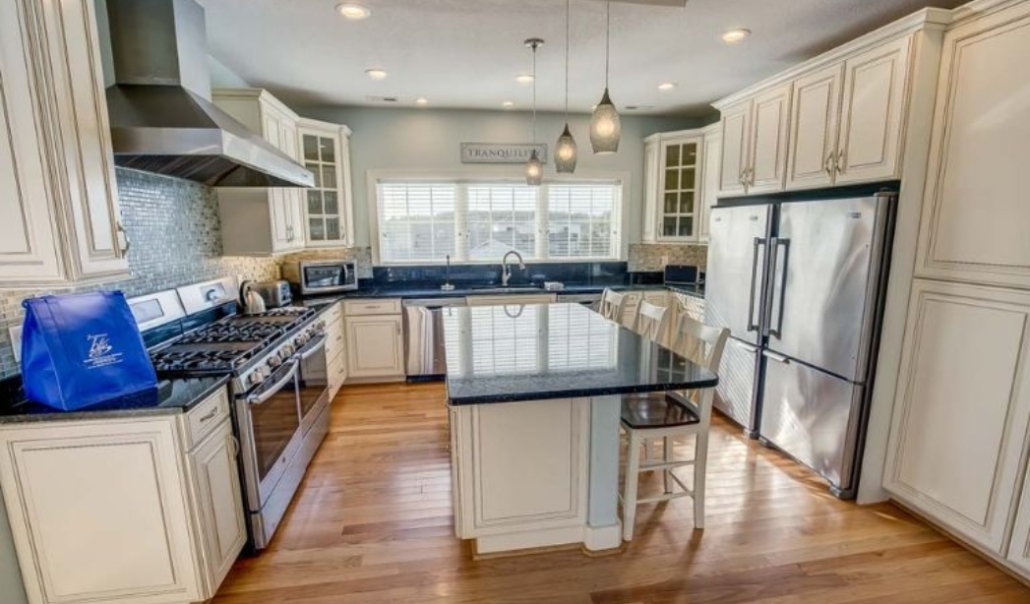 Contemporary kitchen design with white cabinets and stainless steel appliances, highlighting a home improvement project in Virginia Beach.