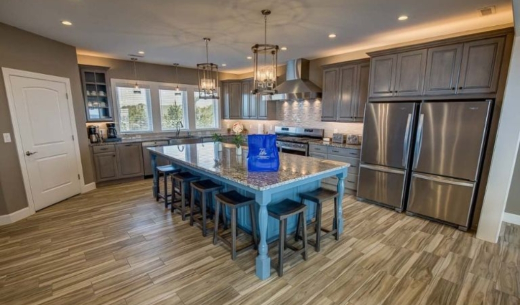Modern kitchen featuring a center island and stainless steel appliances, showcasing home improvement in Virginia Beach.