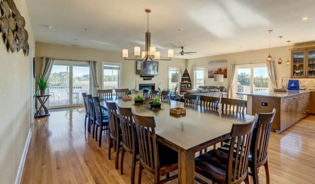 A spacious kitchen and dining area featuring hardwood floors, showcasing a modern home improvement design in Virginia Beach.