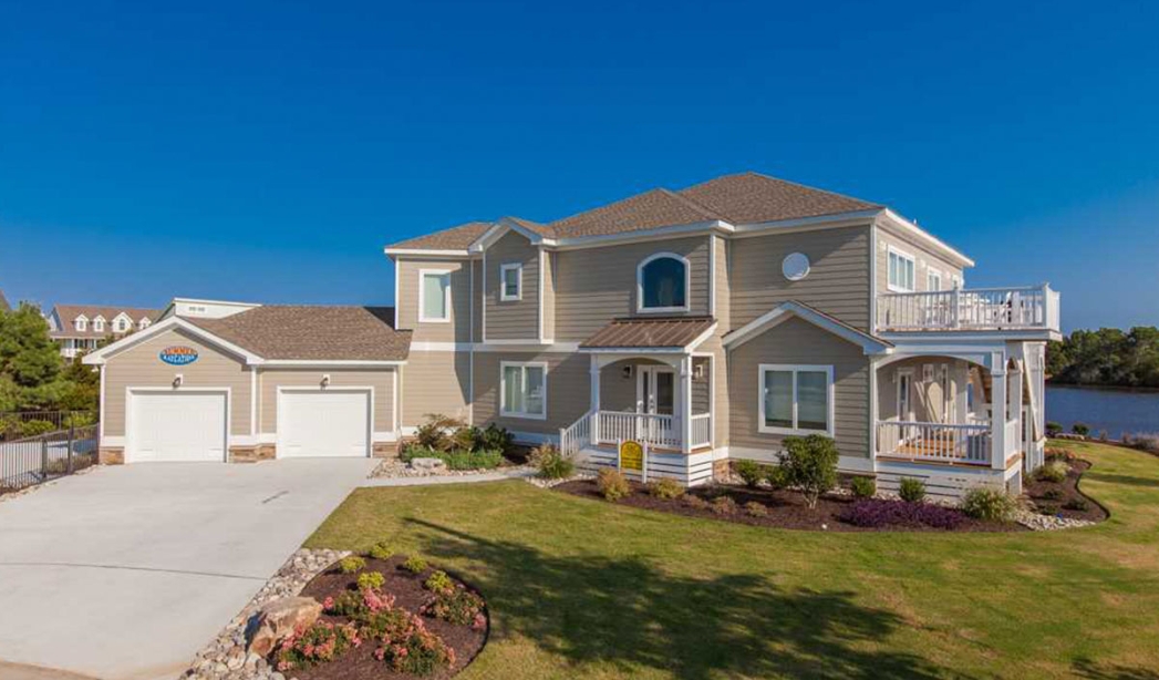 Nimmo Virginia Beach Homebuilders' large home featuring an expansive driveway and a generous yard.