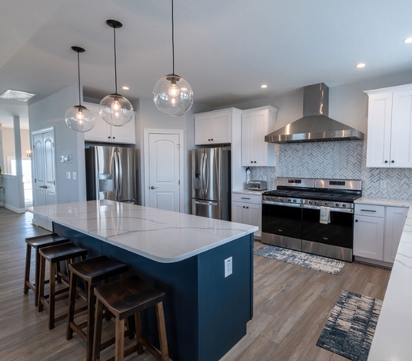 Elegant kitchen with white cabinetry and blue countertops, highlighting the custom design by Nimmo Virginia Beach Homebuilders.