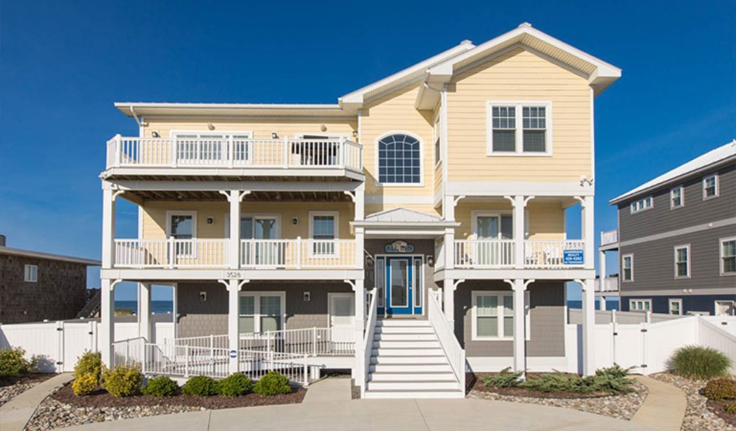 Two-story residence with a balcony and stairs, created by Red Mill Virginia Beach Homebuilders.