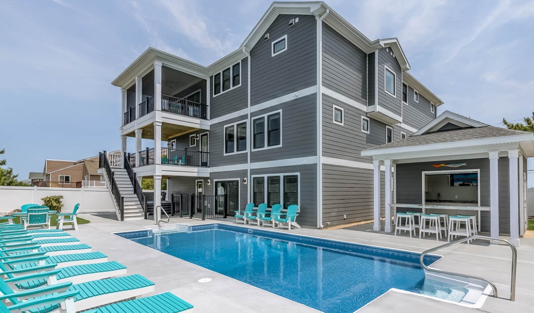 A house with a pool and deck chairs, illustrating a tranquil outdoor setting in Virginia Beach.