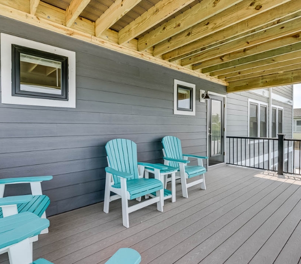 A deck adorned with blue chairs and a porch, emphasizing enhanced protection through siding replacement in Virginia Beach.
