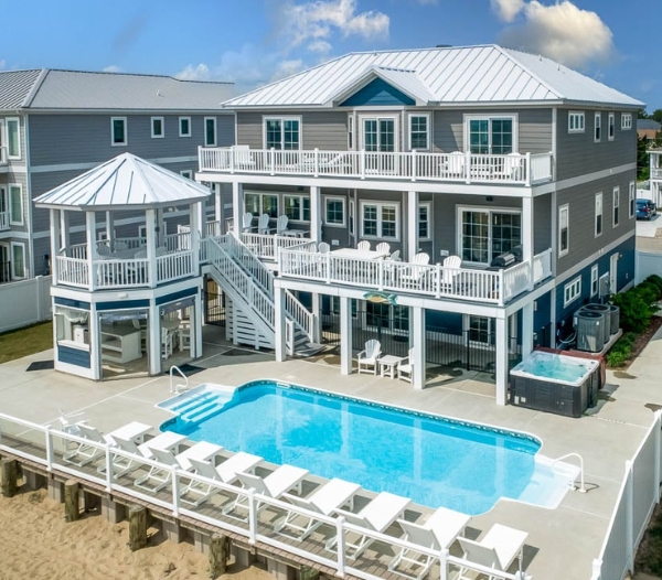 A beach house with a pool and deck, emphasizing low-maintenance siding for coastal living in Virginia Beach.