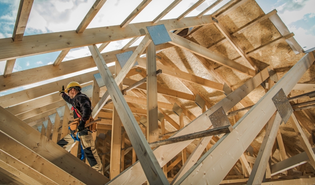 A man constructs a wooden structure, emphasizing the importance of hiring qualified contractors for home renovations.