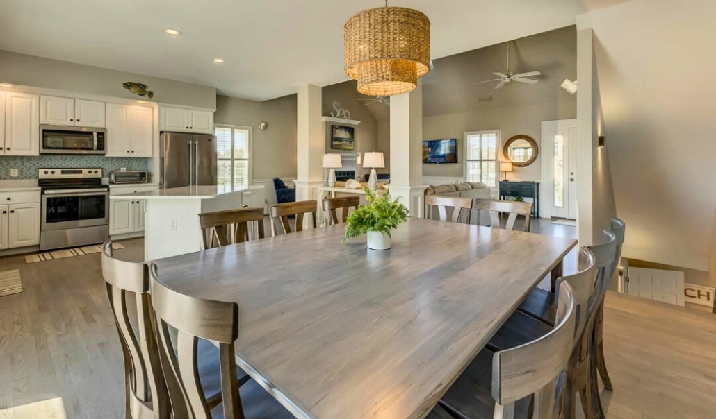 A modern kitchen and dining room featuring a table and chairs, illustrating a home remodel that enhances value.