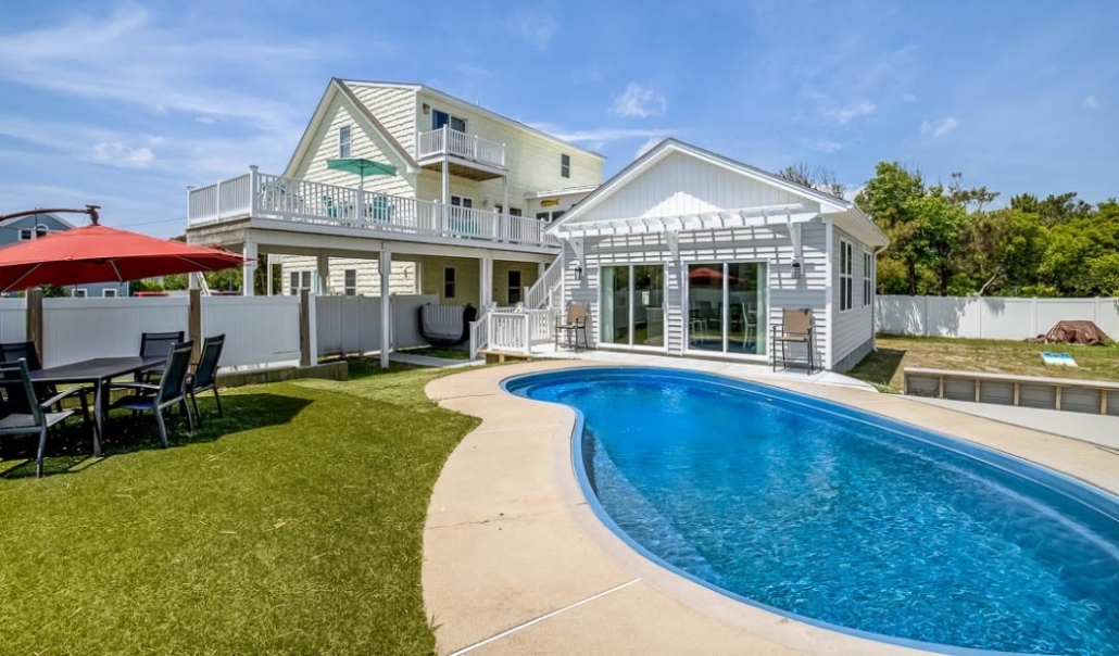 A remodeled house featuring a pool and patio area, showcasing a landscaping upgrade that enhances property value.