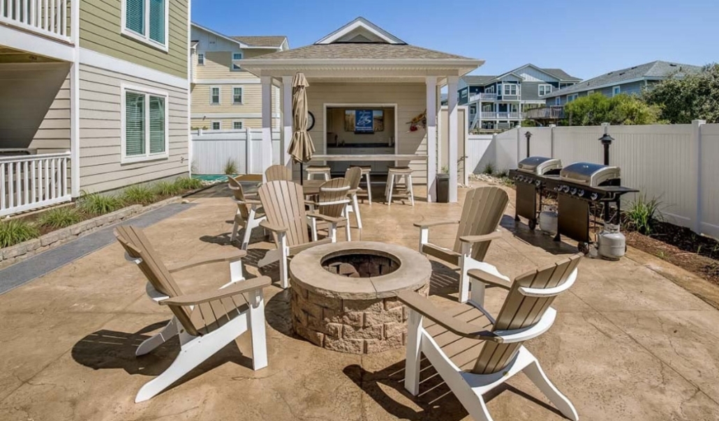 A cozy patio featuring chairs and a fire pit, showcasing a home remodel that enhances outdoor living space.