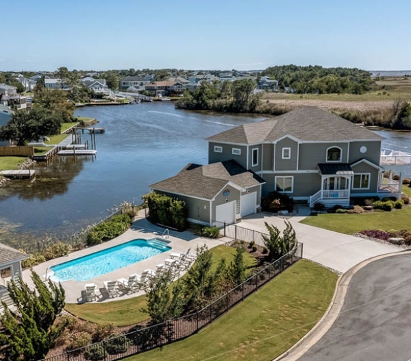 A Kempsville home featuring a pool and dock, highlighting its enhanced value by local builders in Virginia Beach.
