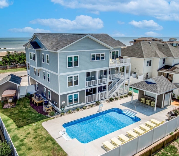 A Kempsville Virginia Beach home featuring a pool and beach, showcasing quality craftsmanship in its design.