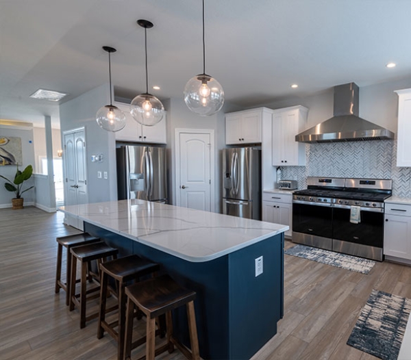 Modern kitchen featuring a large island and stainless steel appliances, showcasing the design by Kempsville Virginia Beach Homebuilders.