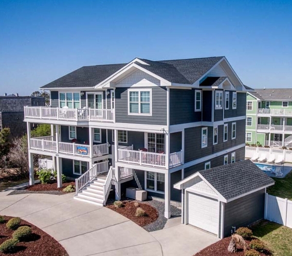 A sizable beach house with a generous deck and yard, highlighting the client-first approach of Ocean Lakes Virginia Beach Homebuilders.