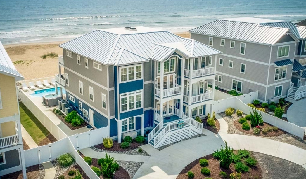 Beachfront home with a pool and deck, designed by Ocean Lakes Virginia Beach Homebuilders.