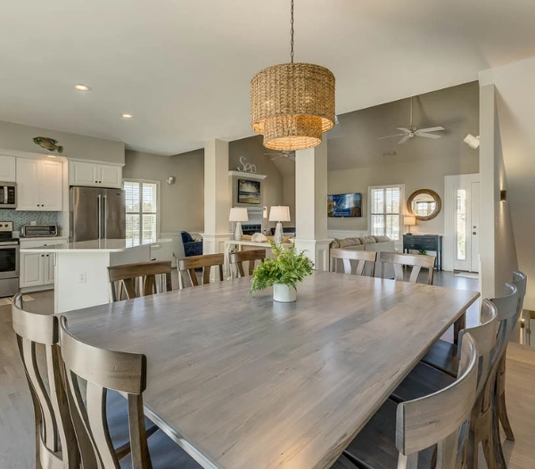 Spacious kitchen and dining area featuring a large table, designed by Ocean Lakes Virginia Beach Homebuilders for home remodels.