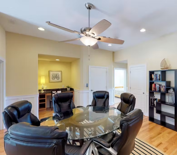 A professional conference room with a central table and chairs, showcasing custom designs by Office Additions Virginia Beach.