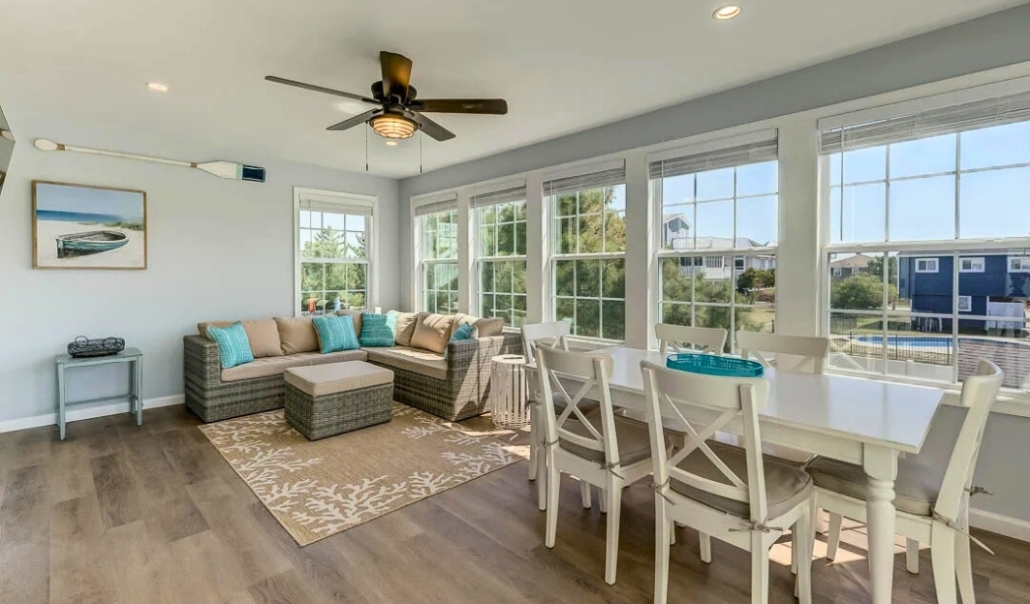 Bright sunroom with a dining table and chairs, highlighting the importance of energy-efficient windows.