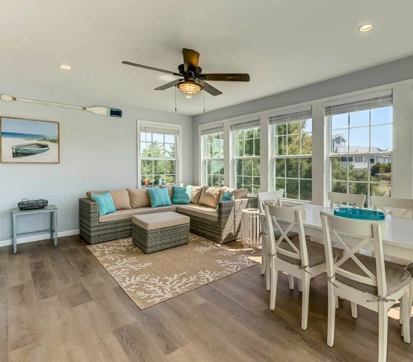 A cozy living room featuring a ceiling fan and a table, highlighting energy-saving upgrades in Virginia Beach remodeling.