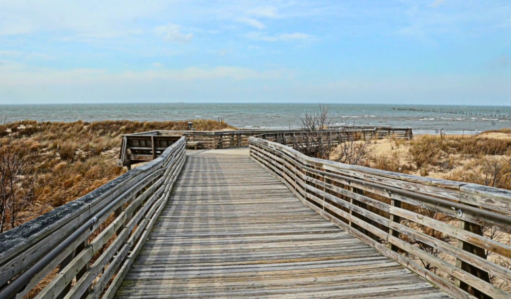 A wooden boardwalk stretches toward the ocean at Virginia Beach's First Landing State Park in November.