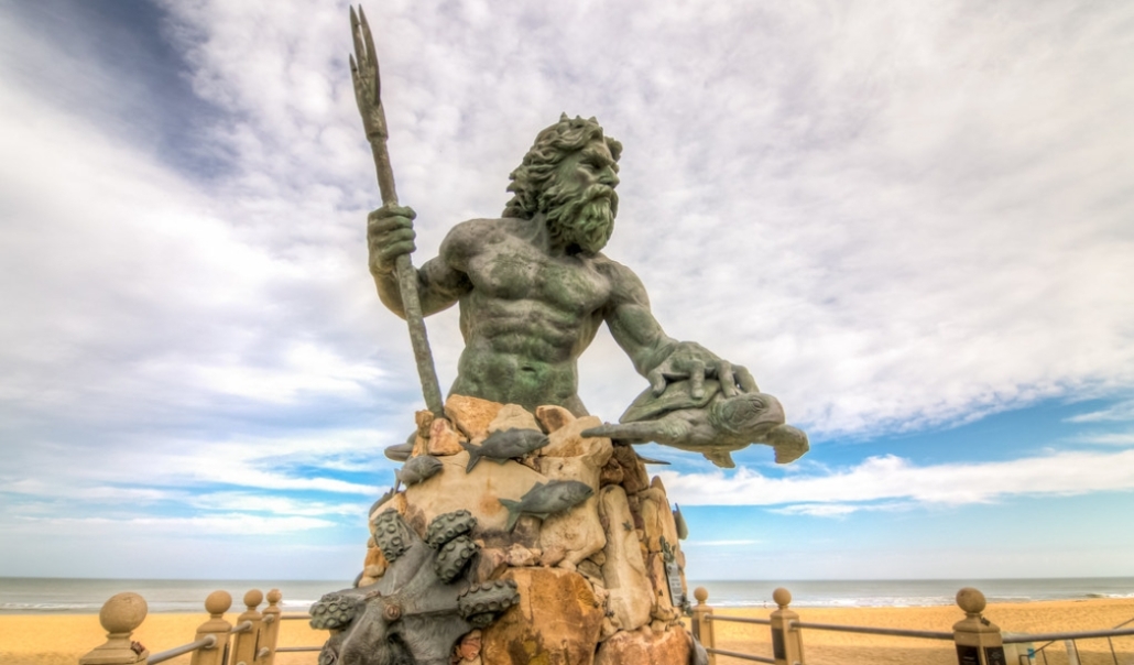 The Neptune statue stands prominently on the beach, symbolizing Virginia Beach's coastal heritage and culture.