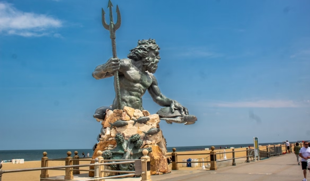 The King Neptune statue on the beach, part of the Virginia Beach Boardwalk attractions.